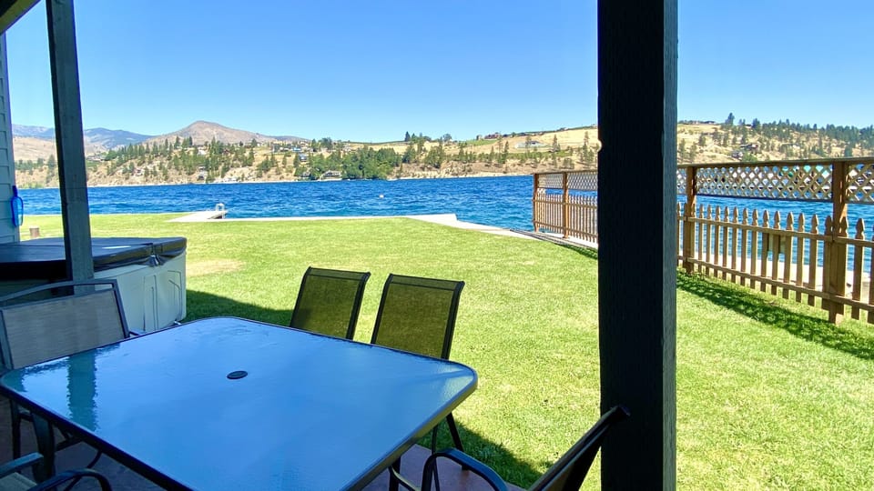 Beautiful views of sunny Lake Chelan! Waterfront living at its best from this lower floor patio - right by the grass, just steps from the lake!
