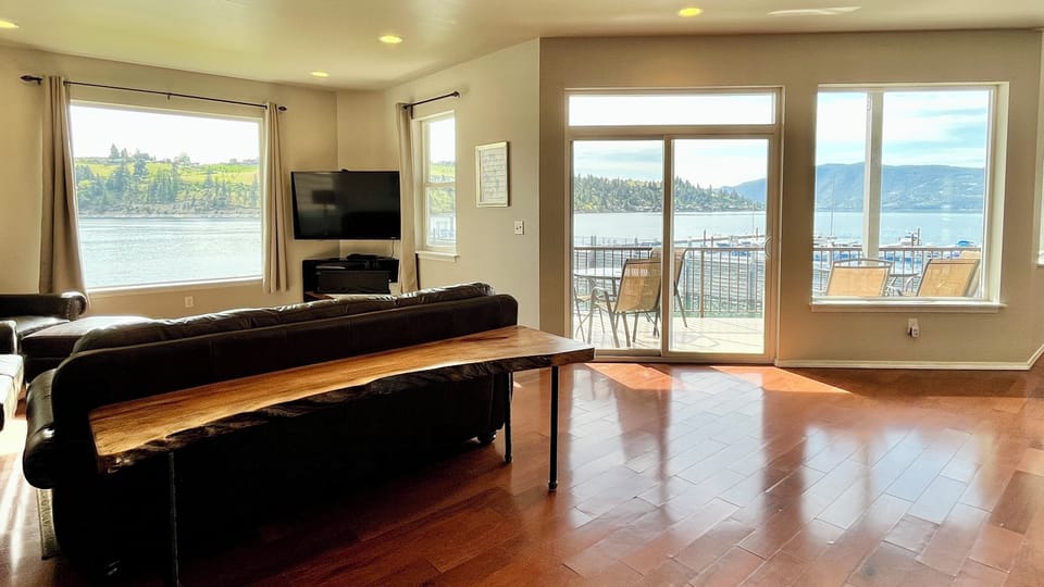 Large open living room on the main floor with multiple windows and views out to Lake Chelan