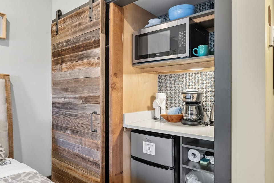 Closet and kitchenette with microwave, coffee maker and mini fridge