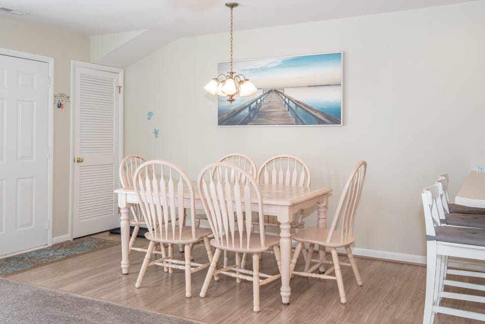 Plenty of seating for dining. Six chairs at table and 3  at breakfast barstools