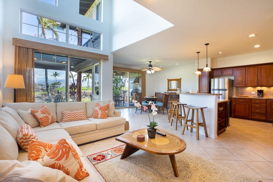 Open-concept living space with vaulted ceilings and abundant natural light, designed for easy indoor-outdoor flow.
