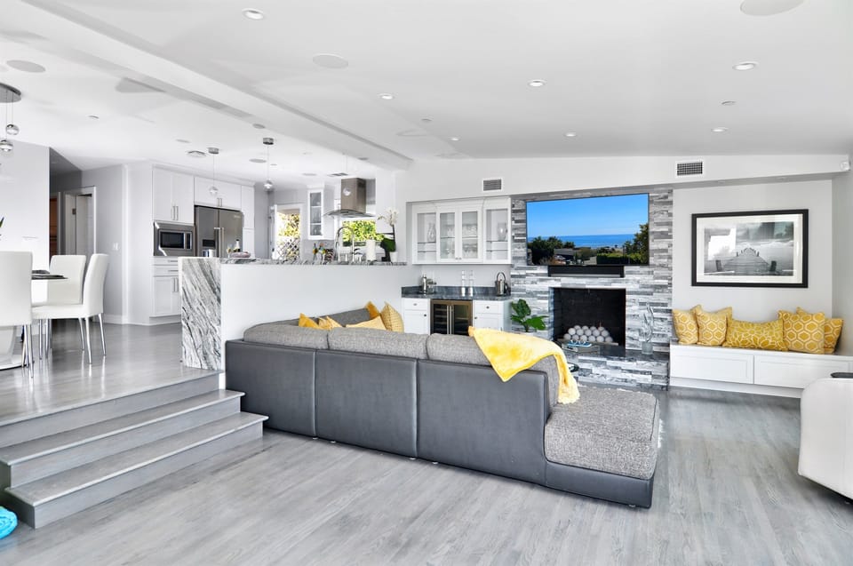 Living Room is the perfect place to relax with a glass of wine from the wine cooler in front of the fireplace