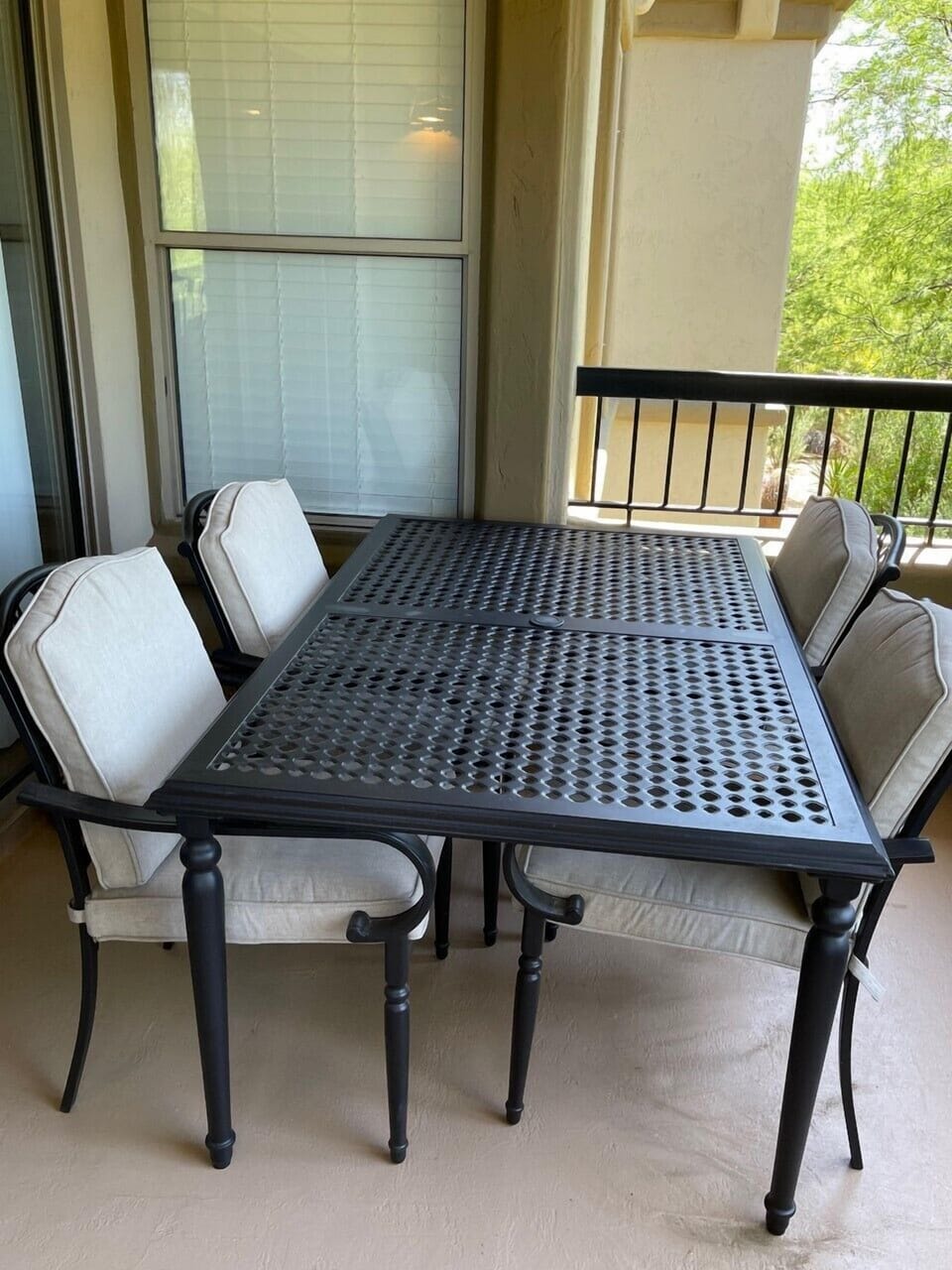 Patio with large table to fit 6, 2 additional chairs are current place on side