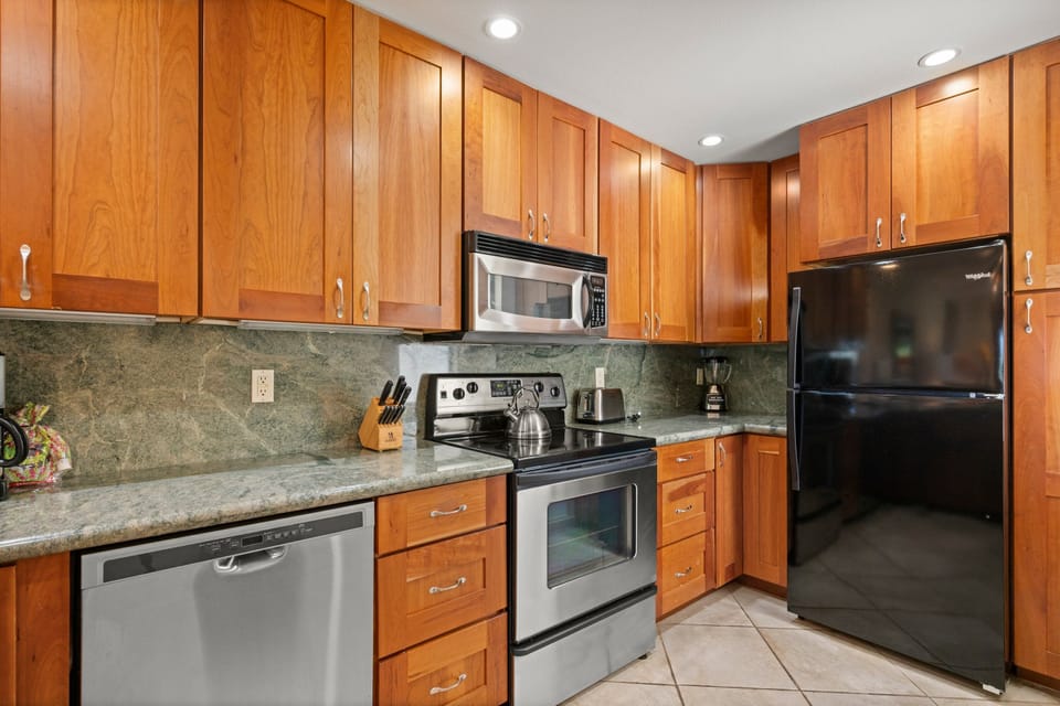 Full size appliances: Stainless steel stove, full-size refrigerator and dishwasher.