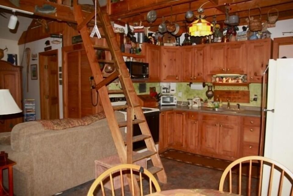 view from slider to kitchen, shows stairs to loft 