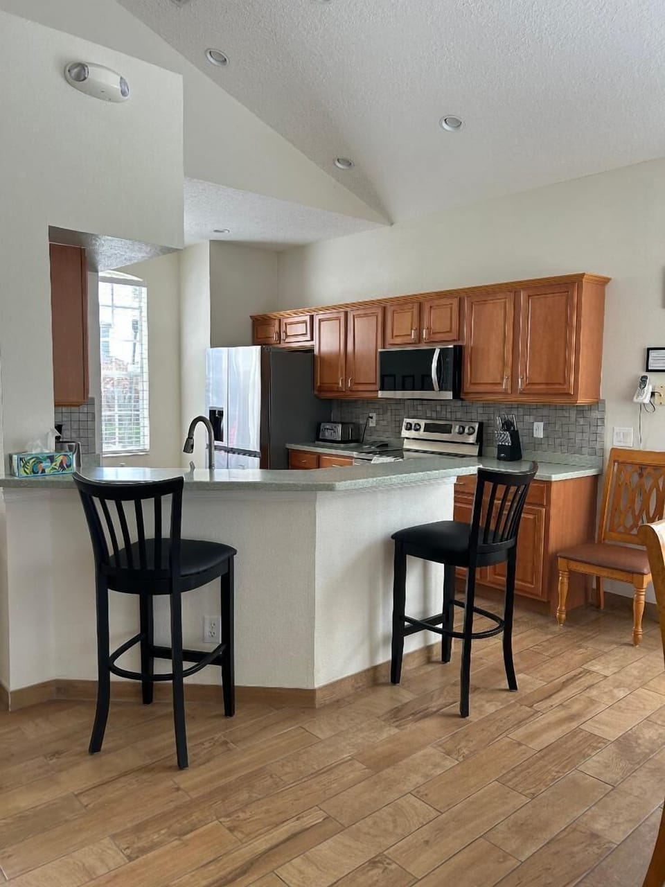 Kitchen with stainless LG appliances and two bar stools