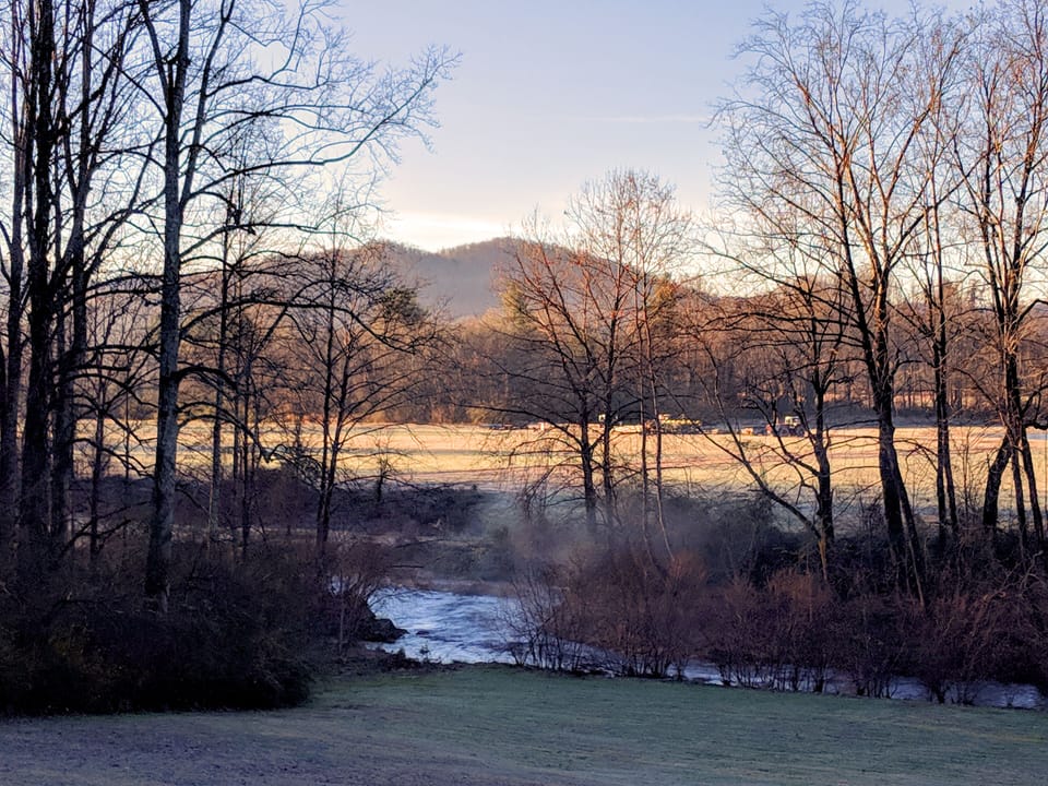 A beautiful stream on the grounds with mountain views beyond.
