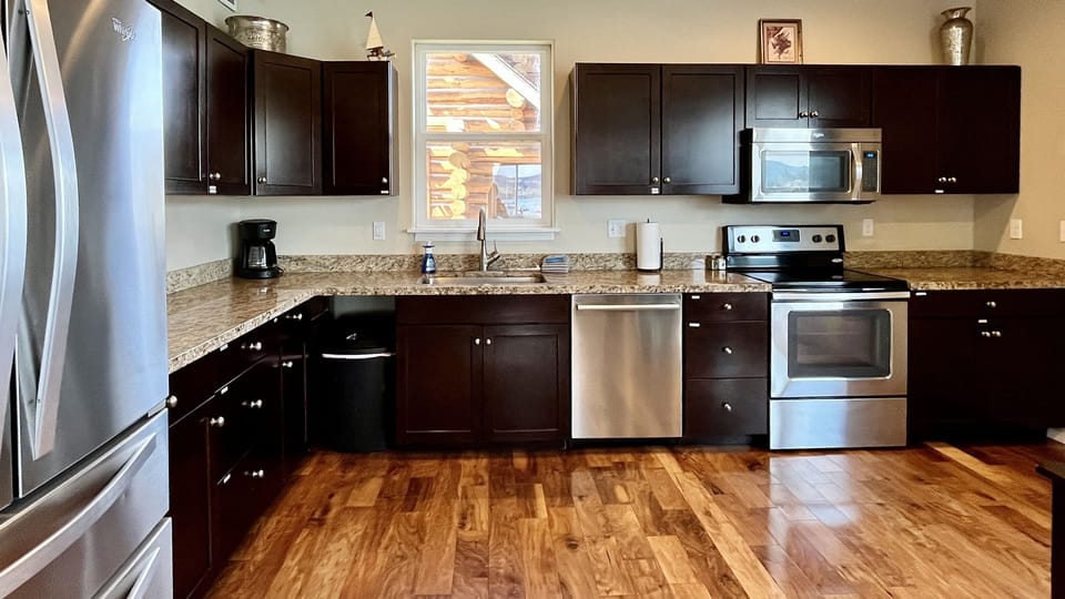 Large open kitchen with granite and stainless appliances - it has great views, too!