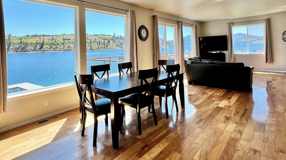 Wall of windows in the living room with beautiful views! Living room leather couches and large flat-screen TV and electric fireplace
