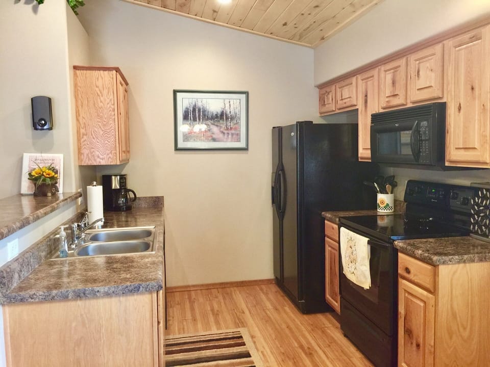 Fully stocked kitchen with breakfast bar. 
