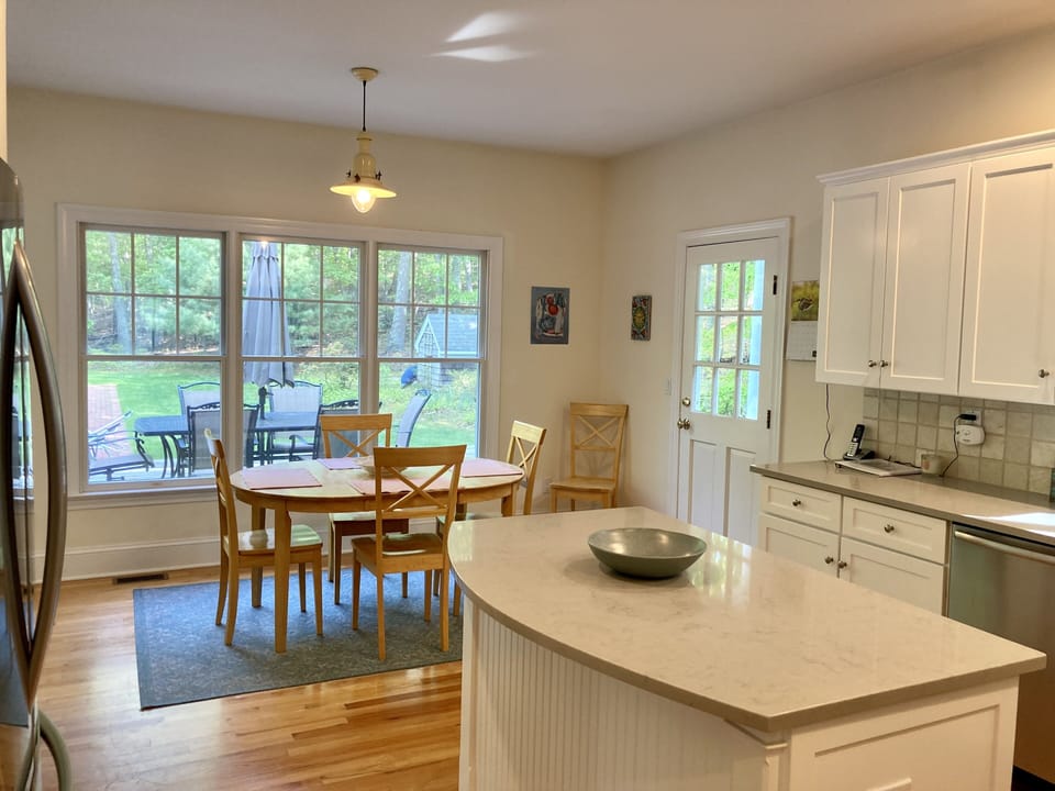 Kitchen table looking out to private backyard and deck