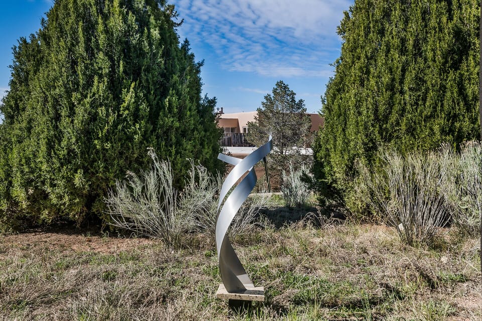 One of several metal sculptures and art panels in the gardens