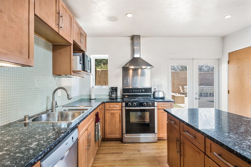 Custom granite counters and island, easy access to outdoor entertaining