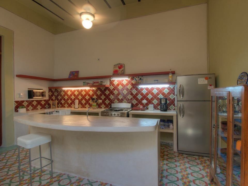 The fully equipped modern kitchen retains it's Mexican colonial charm and style