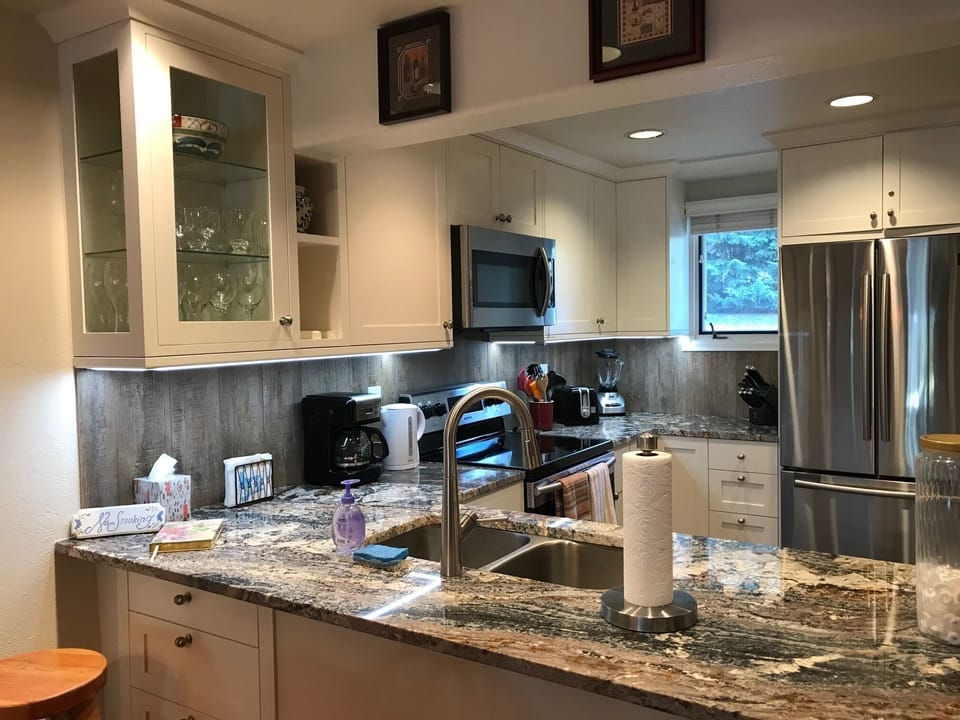 Beautiful granite counter, full-size refrigerator and multiple appliances.