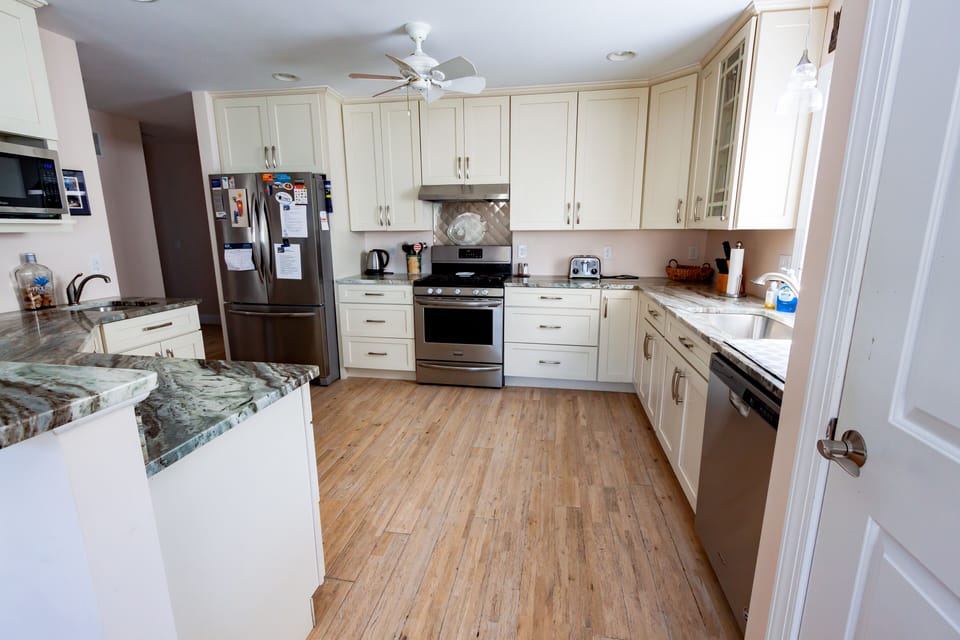 Large fridge with ice maker and five burner stove, dishwasher