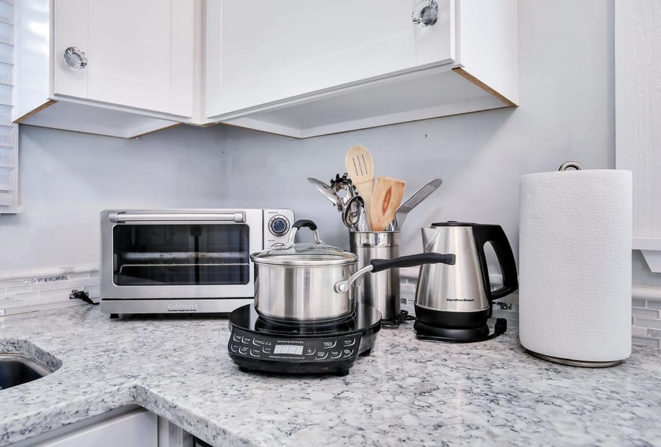 Convenience kitchen includes toaster oven, hot plate & many kitchen essentials.