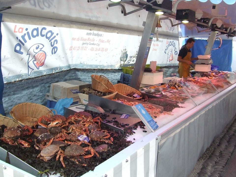 On the market of St Marc/ sea the stand of the fishmonger is well supplied