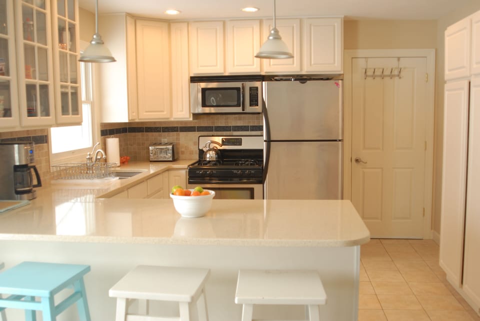 Kitchen with sit at counter and four stools