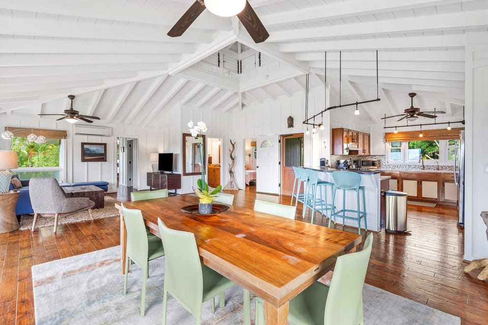 Koa slab dining area with 8 chairs and open floor plan home great for gatherings