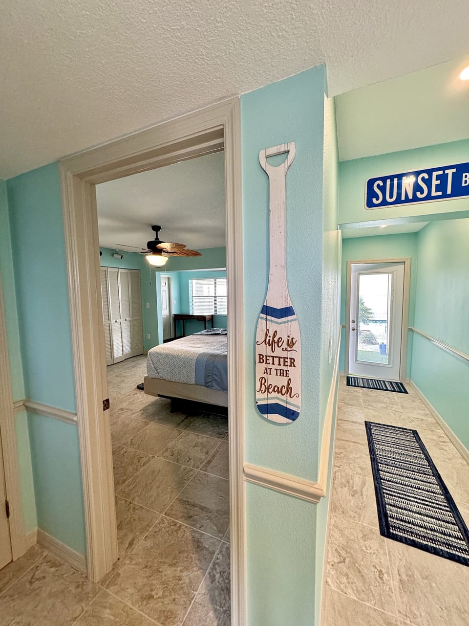 View from front door entryway into hallway & downstairs bedroom 