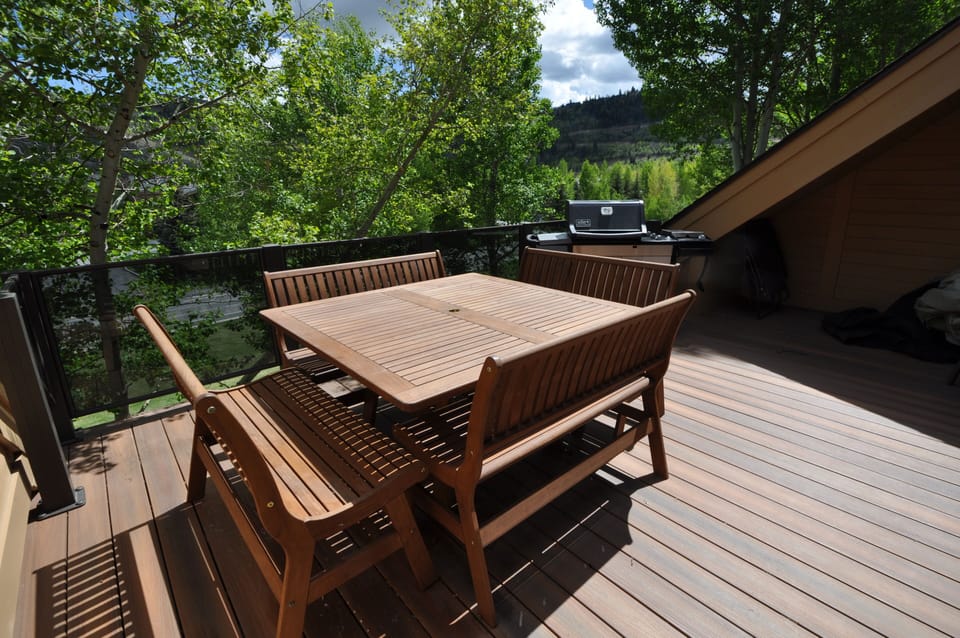 Awesome outside patio with a gas grill and a table that fits 8 people
