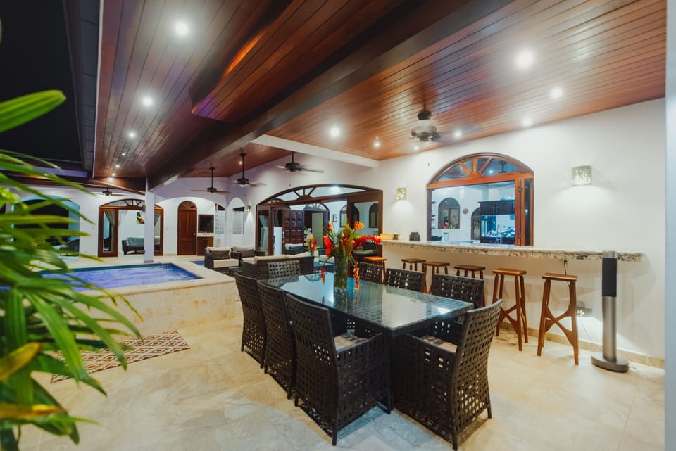 outdoor under roof dinning with pass through bar to the kitchen