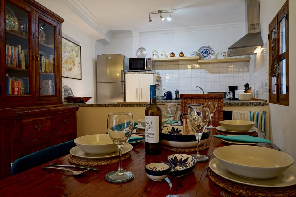 Dining table with a good supply of glasses, crockery etc.