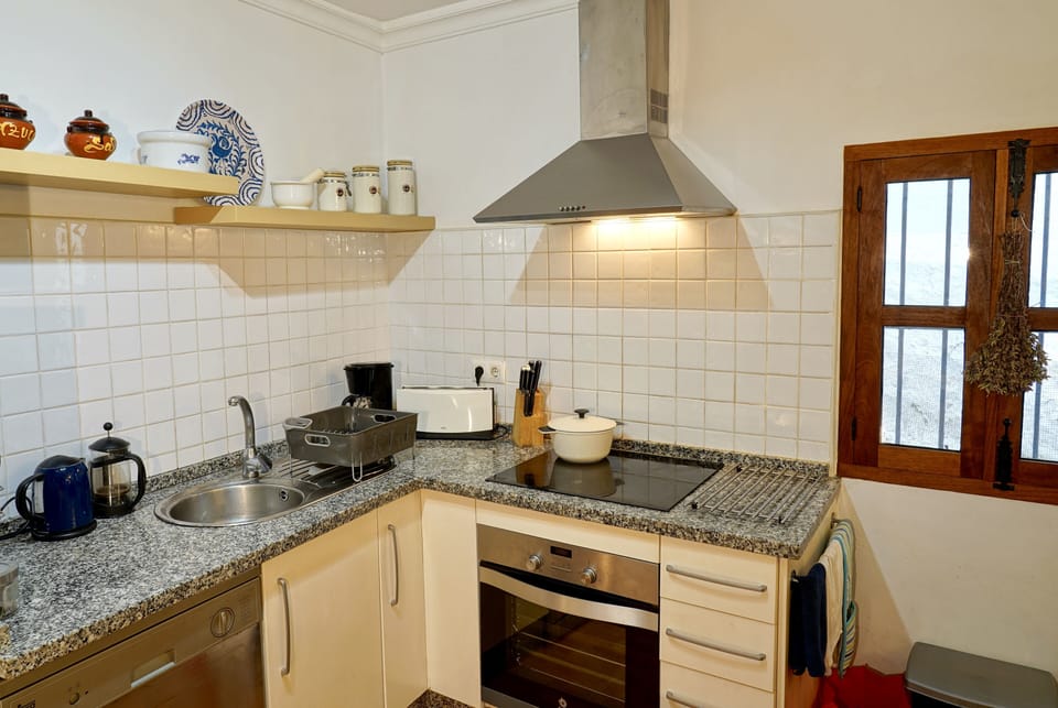 Kitchen area with sink and recently replaced hob and oven.