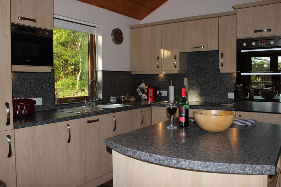 The well equipped, open plan kitchen with views over the garden.