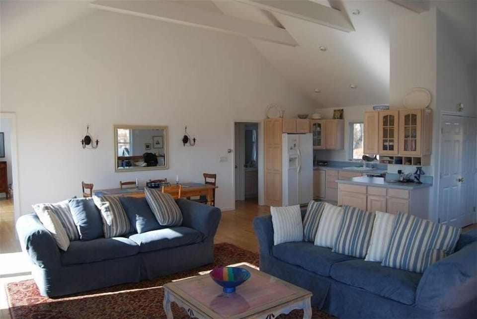 Great room with wood burning fireplace, dining for 10 and kitchen
