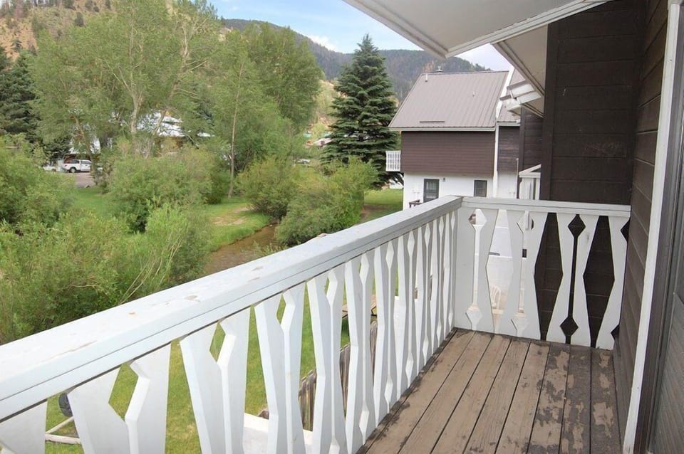 A peaceful village setting surrounded by lush greenery and mountain views, providing a serene backdrop to the property.