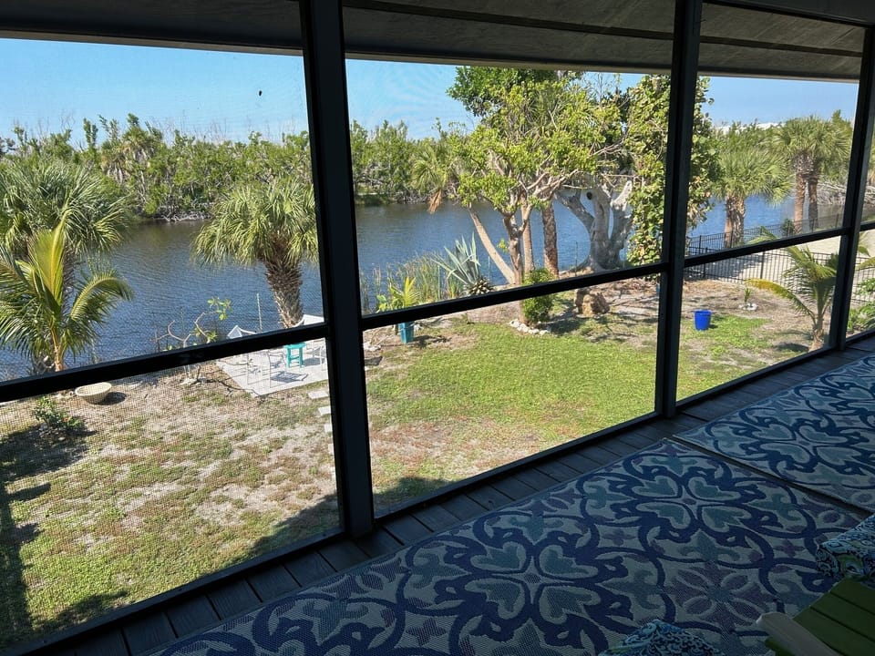 Post-Ian view of Mango House back yard and lake from the Lanai