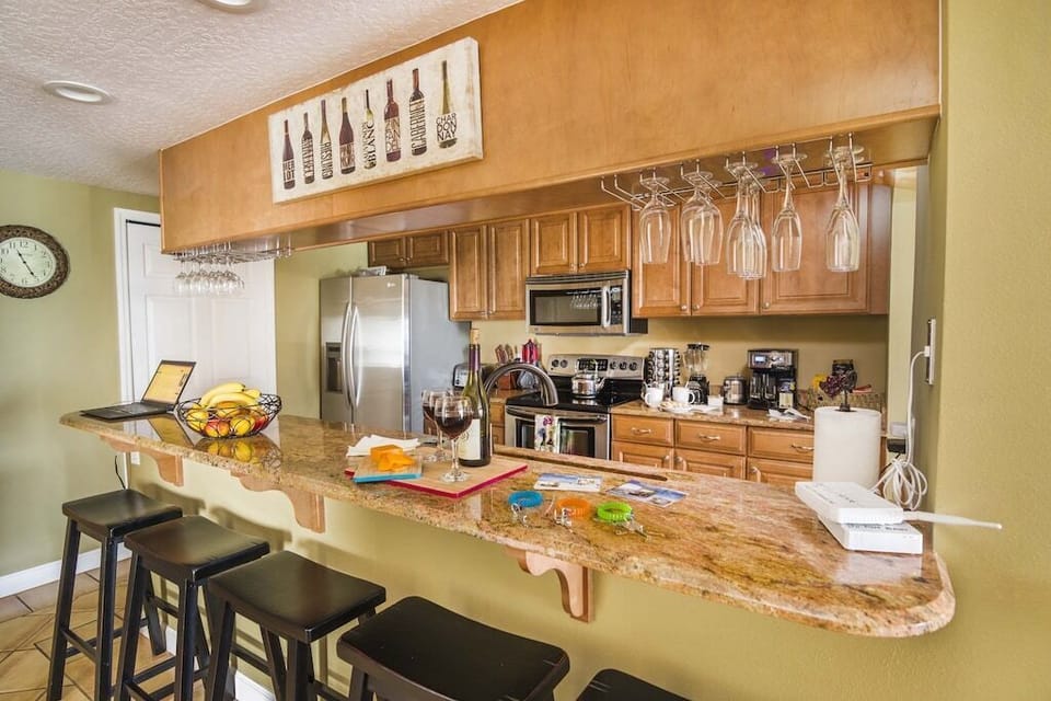 Upscale Kitchen with Granite Counters, Wine Rack and Lunch Bar that Seats 5