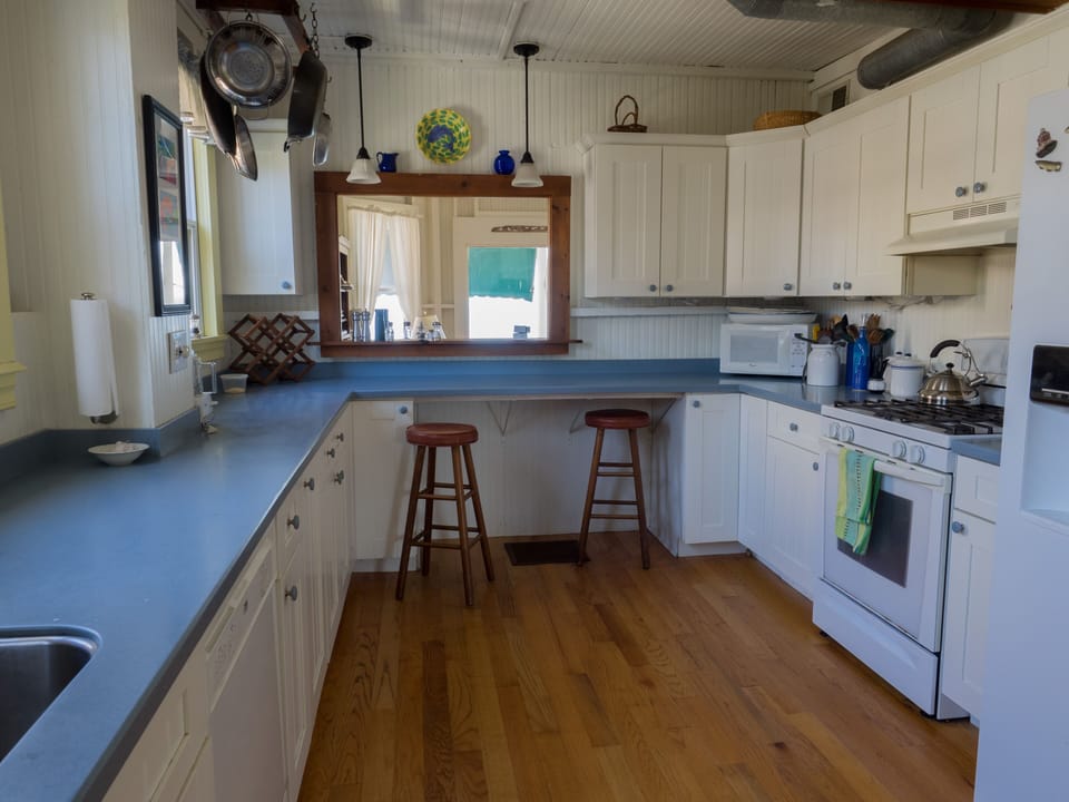 The kitchen is modern with a direct view of the beach and Long Island Sound