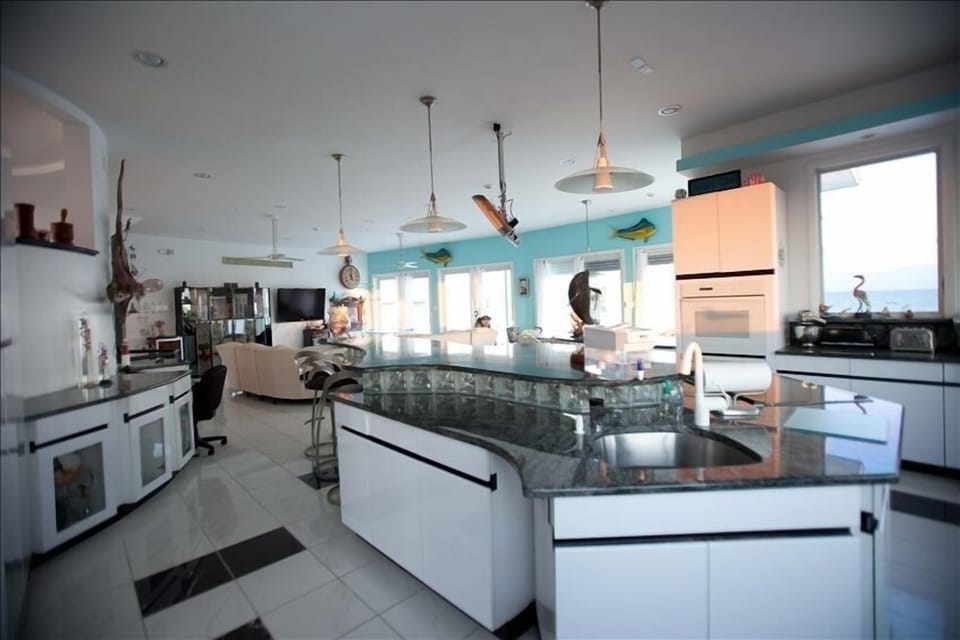 Kitchen Island w/sink, ceramic cook top, island seating for 8. TV above island.