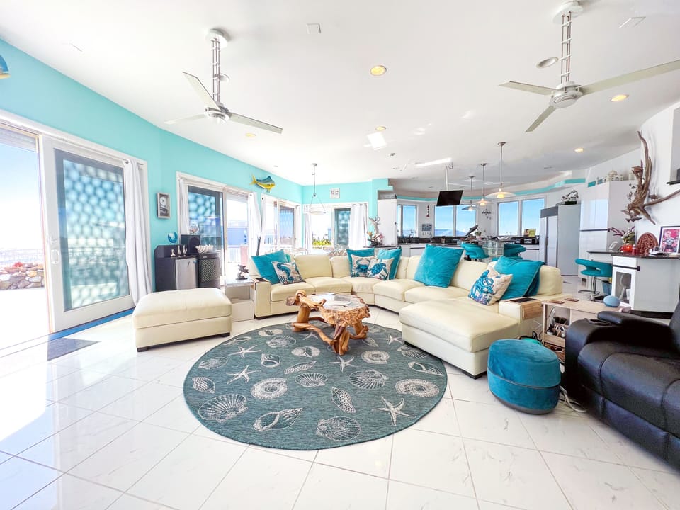 Great room boasts 85” Samsung TV & sound bar, sectional sofa, recliner, wine fri