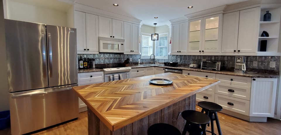 Well-stocked kitchen and large island with mixer, blender, cuisinart & more