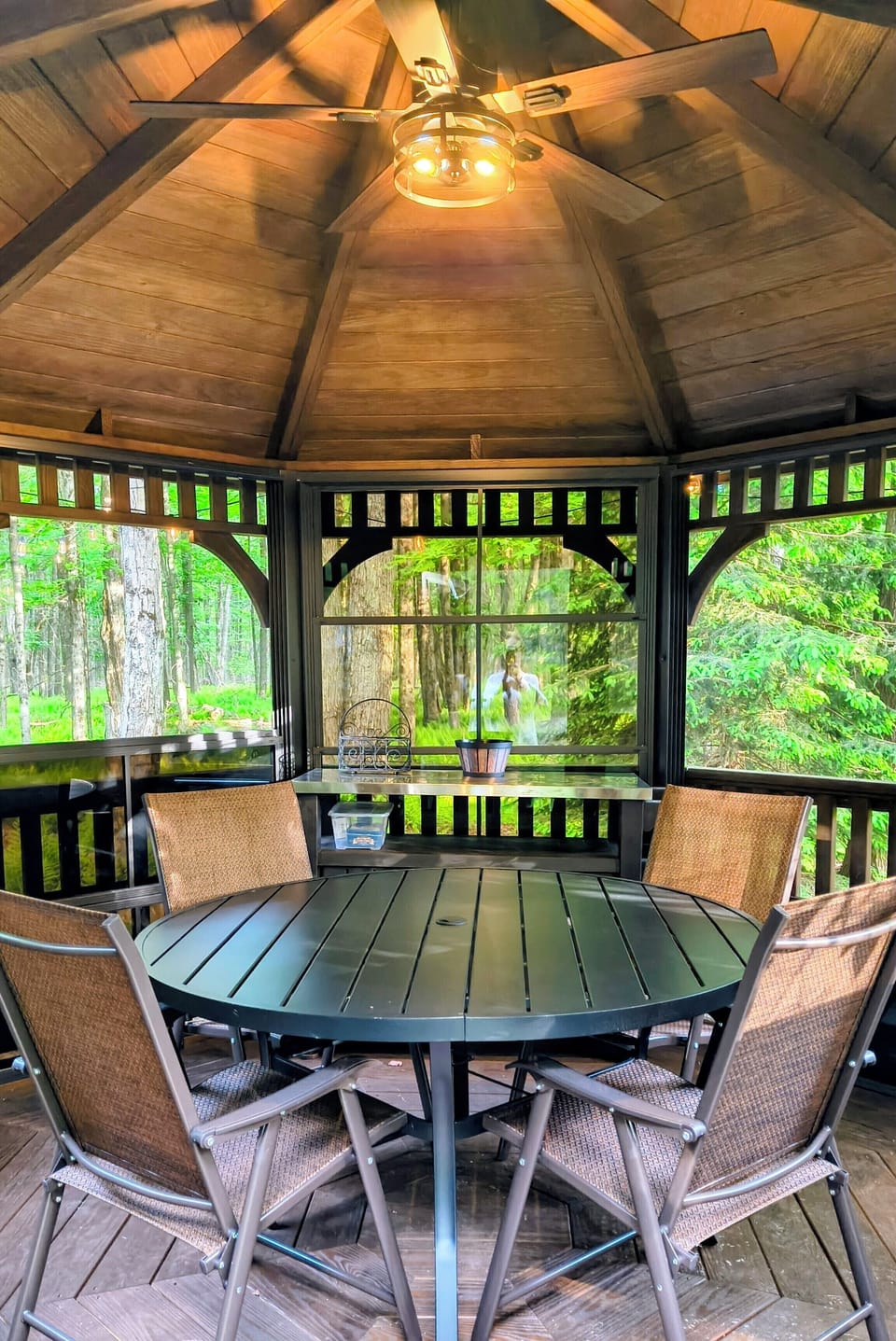 Gazebo interior with beautiful wood hues and woodland views