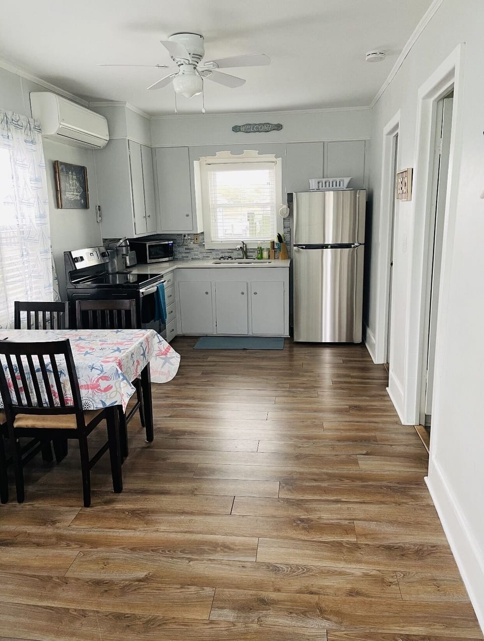 Kitchen with full size fridge, oven, microwave, and Keurig