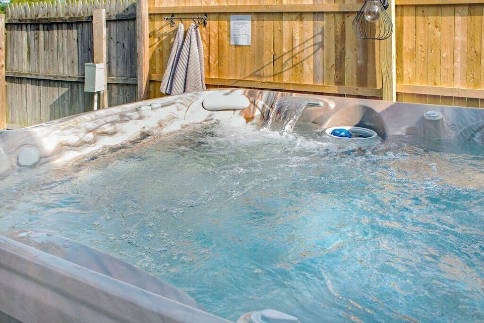 Private hot tub in fenced back yard
