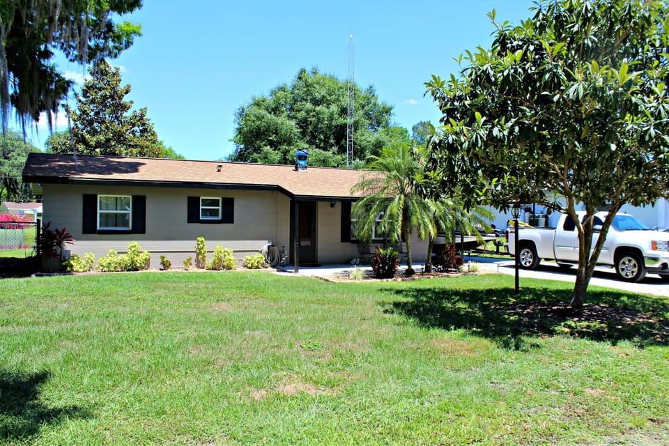 Front View with a boat in the carport