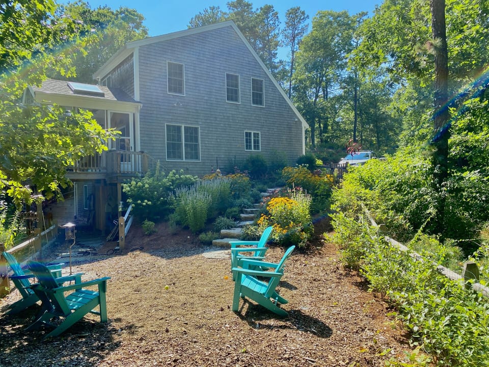 Side of house - showing screened-in porch, and outdoor shower (beneath it)