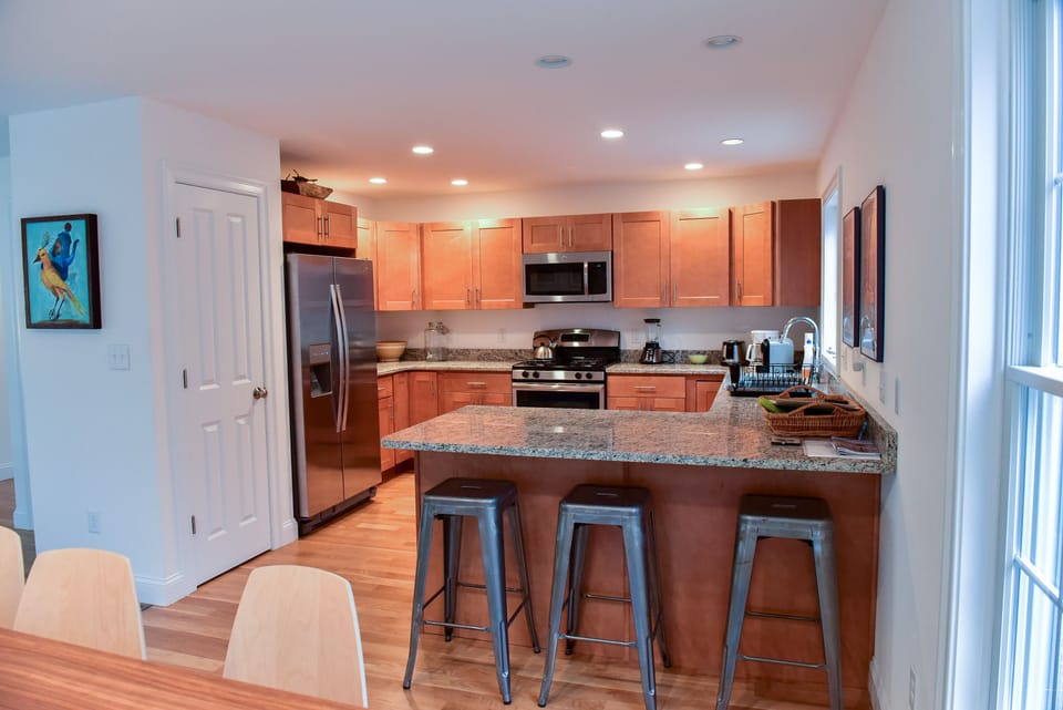 View from dining area towards kitchen, breakfast bar and pantry