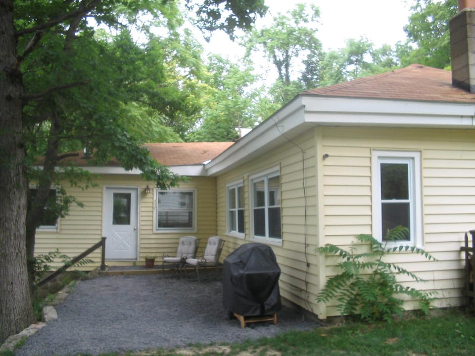 view of house from patio set in yard