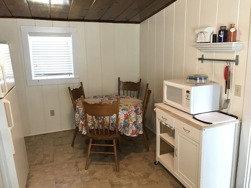 Full fridge, microwave, seats 4.  Bathroom to the left, past the fridge.