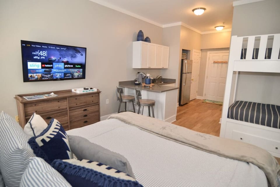 Tv is mounted for optimal viewing from bar to beds