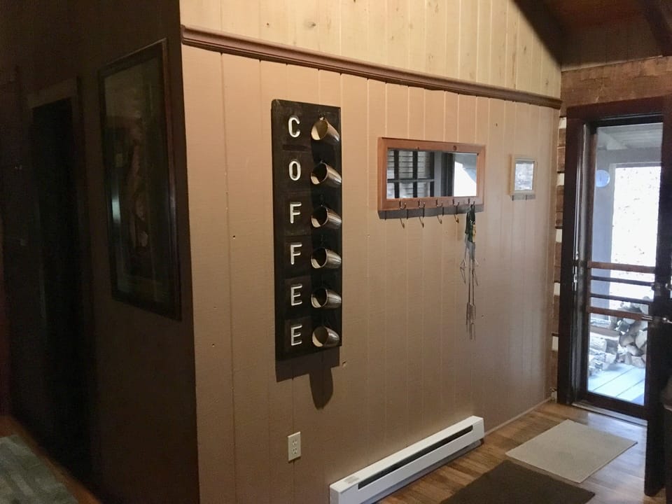 Entry way through back porch door by wood pile