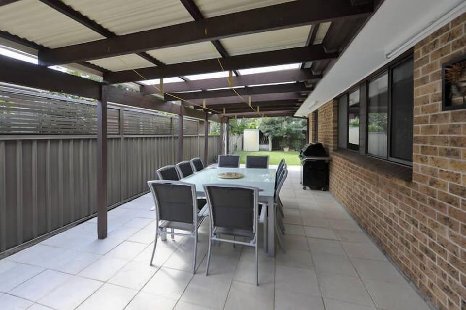 Outdoor undercover area with bbq and extra clothes hanging space.