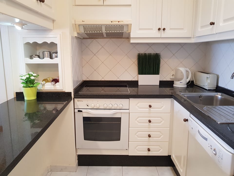 Kitchen with oven, hob, microwave, fridge/freezer, dishwasher and microwave.
